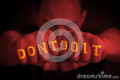 DON`T DO IT written on an angry manâ€™s fists Stock Photo